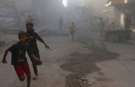 Palestinians inspect the site of an Israeli air strike on a house in Gaza City