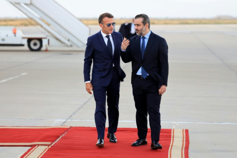 Le président français Emmanuel Macron (g) est accueilli par le ministre syrien des Affaires étrangères Assaad al-Chaibani (d) à son arrivée à l'aéroport international de Damas, pour une visite d'État, le 6 juillet 2026 en Syrie ( AFP / Ludovic MARIN )