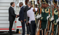 Le président français Emmanuel Macron (à gauche) est accueilli par le ministre sud-africain de la Gouvernance coopérative et des Affaires traditionnelles, Velenkosini Hlabisa (2e à gauche), à l'aéroport international de Johannesburg (Afrique du Sud), le 21 novembre 2025 ( AFP / Ludovic MARIN )