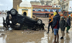 Des Marocains regardent un véhicule renversé et d'autres débris après une crue soudaine, dans la ville côtière de Safi, à environ 300 kilomètres au sud de la capitale Rabat, le 15 décembre 2025 ( AFP / - )