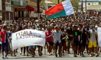 Des manifestants malgaches à Antsiranana brandissent le drapeau national et une banderole appelant le président Andry Rajoelina à partir, à Antananarivo le 1er octobre 2025 ( AFP / FITA )