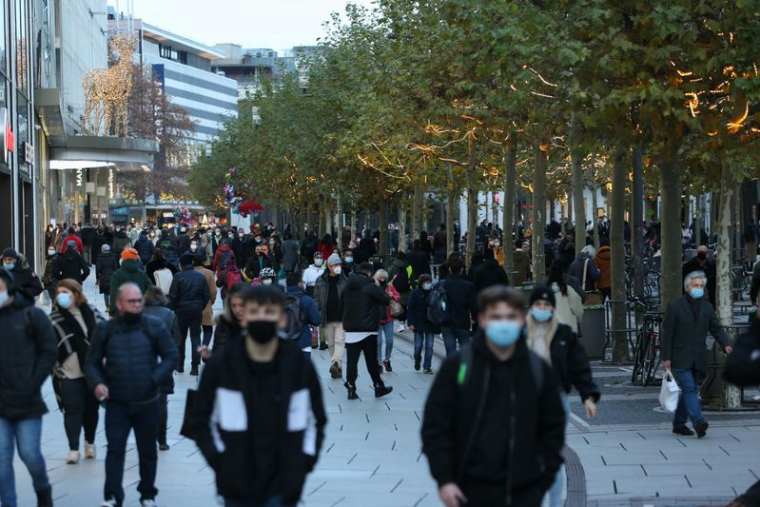 People walk along the Zeil shopping promenade, in Frankfurt