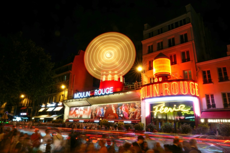 Les nouvelles ailes du Moulin Rouge tournent alors que le cabaret célèbre leur remise en service, à Paris, le 10 juillet 2025 ( AFP / Dimitar DILKOFF )