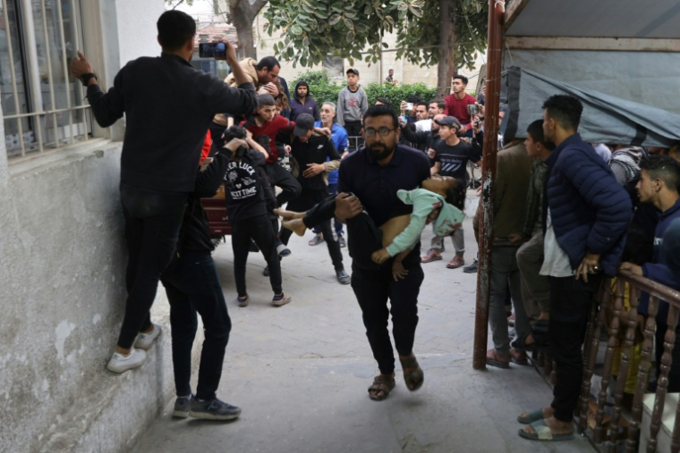 Un Palestinien transporte une fillette blessée à l'hôpital al-Ahli à Gaza-ville, le 6 avril 2025 ( AFP / Omar AL-QATTAA )