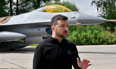 Volodymyr Zelensky, devant un F-16 de l'armée ukrainienne, le 4 août 2024 ( AFP / SERGEI SUPINSKY )