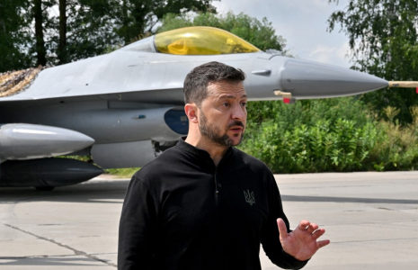 Volodymyr Zelensky, devant un F-16 de l'armée ukrainienne, le 4 août 2024 ( AFP / SERGEI SUPINSKY )