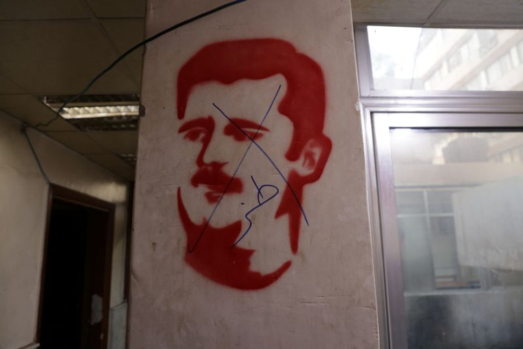 Une image défigurée de Bachar al-Assad en Syrie poste de police de Marja à Damas