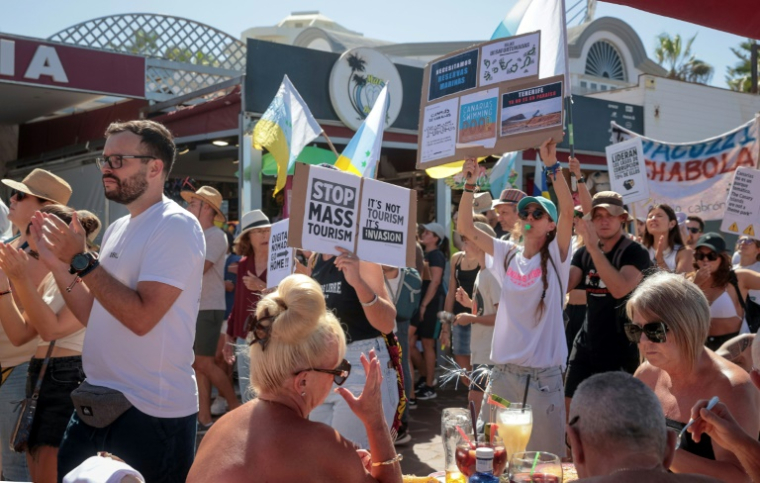 Manifestation sur la plage de Las Americas à Arona contre le tourisme de masse, sur l'île espagnole de Tenerife, aux Canaries, le 20 octobre 2024 ( AFP / DESIREE MARTIN )