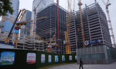 Une personne passe devant un chantier de construction dans le quartier central des affaires (CBD) de Pékin.