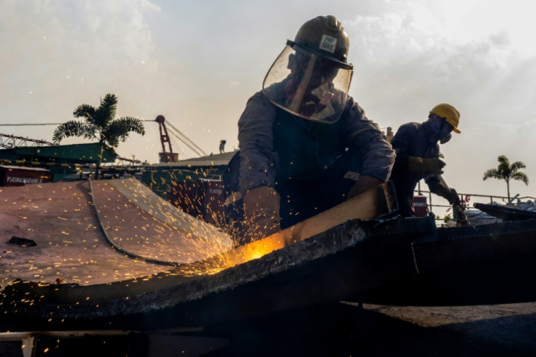 Des employés sur le chantier PHP de démantèlement de bateaux, dans la ville portuaire de Chittagong, le 18 février 2025 dans le sud du Bangladesh ( AFP / Munir UZ ZAMAN )