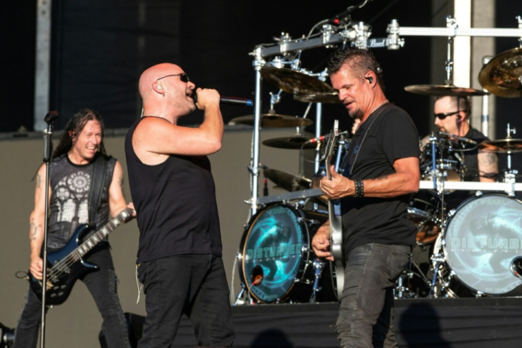 (g-d) John Moyer, David Draiman, Dan Donegan et Mike Wengren du groupe Disturbed en concert à Austin, le 13 octobre 2018 au Texas ( AFP / SUZANNE CORDEIRO )