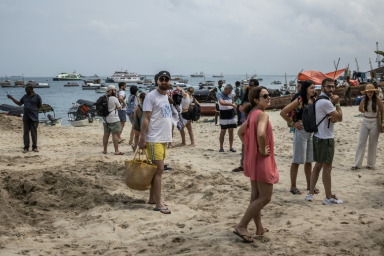Des touristes sur la plage de Stone Town, en Tanzanie, le 24 octobre 2025 ( AFP / MARCO LONGARI )