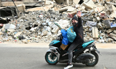 Un homme transportant des effets personnels passe à moto devant des destructions, alors que des habitants libanais regagnent leur quartier dans la banlieue sud de Beyrouth après l’entrée en vigueur, le 17 avril 2026, d’un cessez-le-feu de 10 jours avec Israël. ( AFP / FADEL itani )