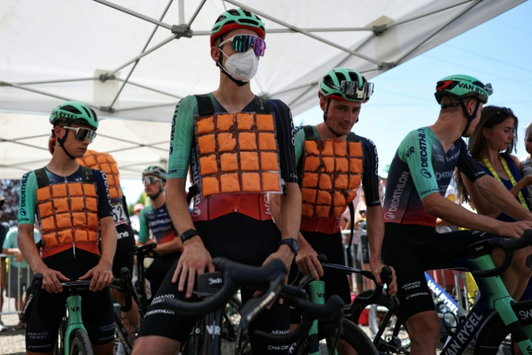 Des coureurs de Decathlon CMA CGM dont Paul Seixas (au centre) portent des gilets refrigérants au départ de la 9e étape du Tour de France, le 12 juillet 2026 à Malemort ( AFP / Anne-Christine POUJOULAT )