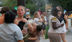 Des personnes se rafraîchissent en traversant un fin brouillard d'eau dans le centre de Paris le 21 juin 2025 ( AFP / ROMAIN PERROCHEAU )