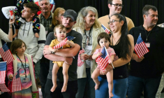 The first group of white Afrikaners to arrive in the United States for resettlement pose for photographers at Dulles Airport in Virginia ( AFP / SAUL LOEB )