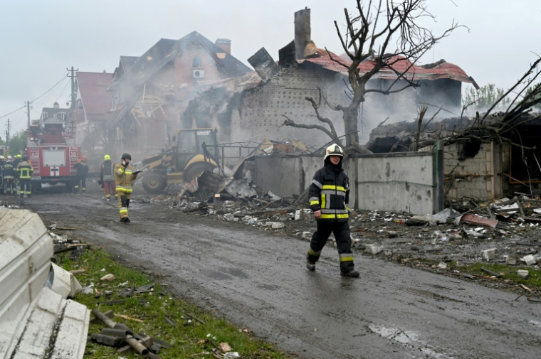 Des pompiers interviennent sur un incendie dans des maisons endommagées par une frappe russe dans la région de Kiev, le 25 mai 2025 en Ukraine ( AFP / Sergei SUPINSKY )