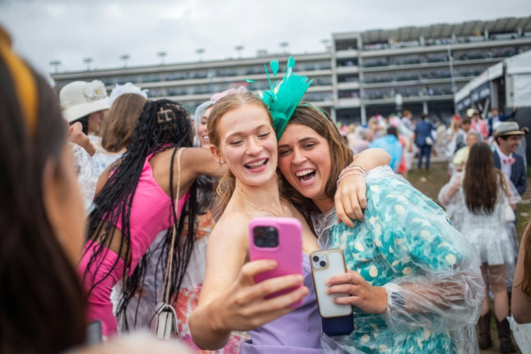 Des amies sourient pour un selfie lors de la 151e édition du Kentucky Derby à Louisville (Kentucky), aux Etats-Unis, le 3 mai 2025 ( AFP / LEANDRO LOZADA )
