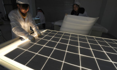 Des employés travaillent sur une ligne de production de panneaux solaires dans l'atelier d'une société solaire à Hefei