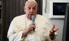 FILE PHOTO: Pope Francis holds a news conference aboard the papal plane