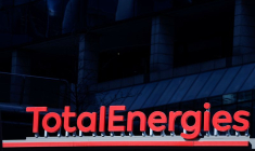 Signage for TotalEnergies at a gas station in the La Defense business district in Paris