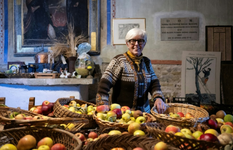 L'agronome italienne Isabella Dalla Ragione pose dans une petite église où elle entrepose des fruits cultivés par sa fondation à but non lucratif Archeologia Arboreas, à San Lorenzo di Lerchi, un hameau de Città di Castello, en Italie, le 7 novembre 2025 ( AFP / Tiziana FABI )