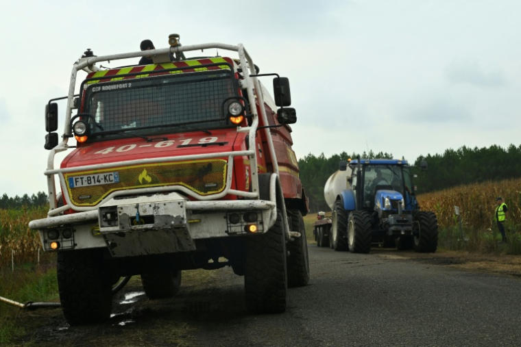 Des pompiers et des agriculteurs remplissent leur citerne d'eau, le 16 août 2026 à Luglon, dans les Landes  ( AFP / Gaizka IROZ )