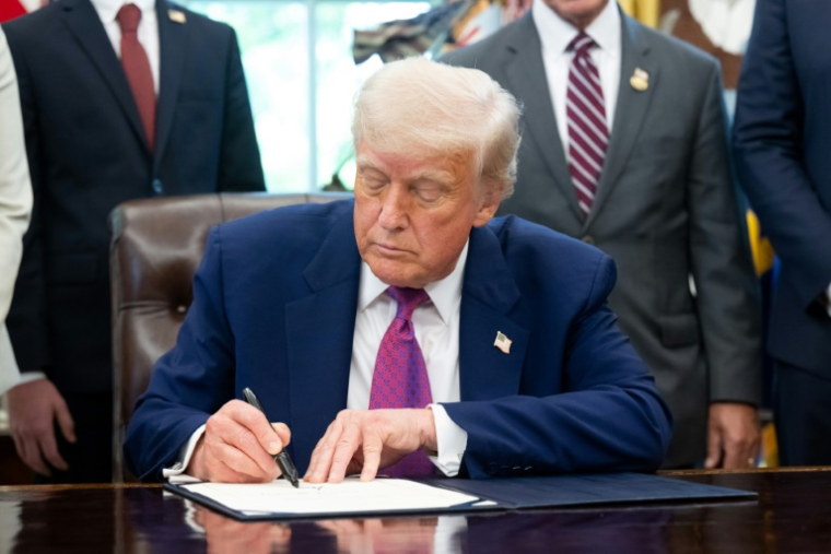 Le président américain Donald Trump signe un décret, le 9 mai 2025 dans le Bureau ovale de la Maison Blanche, à Washington ( AFP / SAUL LOEB )