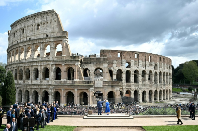 Britain's King Charles III and Queen Camilla greet the crowd in front of the Colosseum in Rome as part of a four-days state visit in Italy, on April 8, 2025. ( AFP / Paul ELLIS )