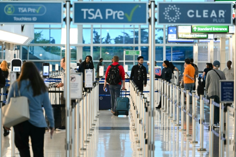 Des voyageurs passent dans des files de sécurité à l'aéroport Ronald Reagan, près de Washington, le 1er octobre 2025 ( AFP / ANDREW CABALLERO-REYNOLDS )