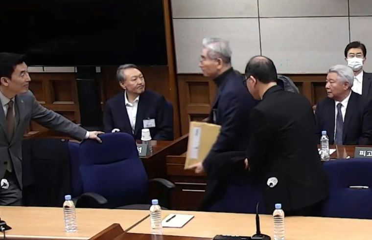 Cette capture d'écran tirée d'une vidéo distribuée par le tribunal central de Séoul et diffusée par l'agence Yonhap montre l'ex-président sud-coréen Yoon Suk Yeol (2e à gauche) assistant à son procès pour insurrection à Séoul, le 19 février 2026 ( YONHAP / Handout )