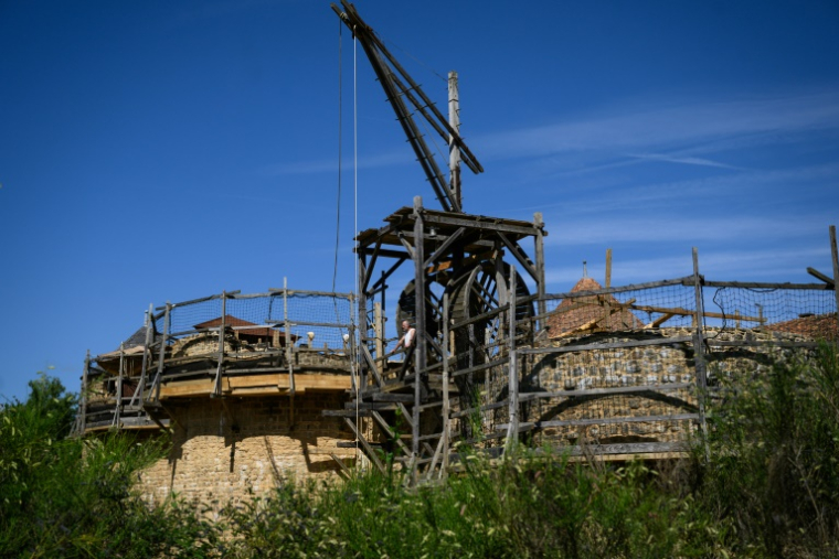 Une grue à tapis roulant (également connue sous le nom de "cage d'écureuil") sur le chantier de construction du château de Guédelon, un château médiéval construit uniquement selon les méthodes du XIIIe siècle, à Treigny, le 23 juin 2025 dans l'Yonne ( AFP / ARNAUD FINISTRE )