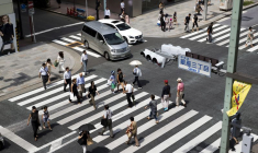 Des personnes traversent une rue dans le quartier de Ginza à Tokyo, au Japon