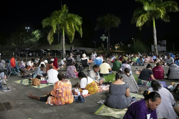 Des participantes jouent au bingo sur le parking d'un centre commercial désaffecté, dans le quartier de Rivière-Salée à Nouméa, en Nouvelle-Calédonie, le 8 mai 2025 ( AFP / Delphine MAYEUR )