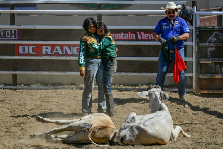 Christel Mae Firme (G) et sa partenaire après avoir concouru lors d'une compétition de rodéo organisée dans la province philippine de Masbate, le 15 avril 2026 ( AFP / Jam STA ROSA )