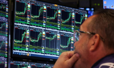 FILE PHOTO: Traders work on the floor of the NYSE in New York