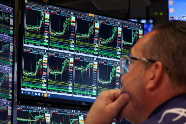 FILE PHOTO: Traders work on the floor of the NYSE in New York