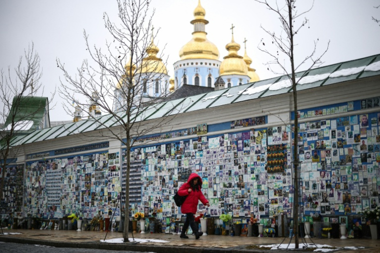 Une personne passe devant le Mur du Souvenir des Morts pour l'Ukraine à Kiev, le 25 février 2026 ( AFP / HENRY NICHOLLS )