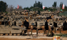 FILE PHOTO: Israeli soldiers work by military vehicles, near the border with Gaza, in Israel