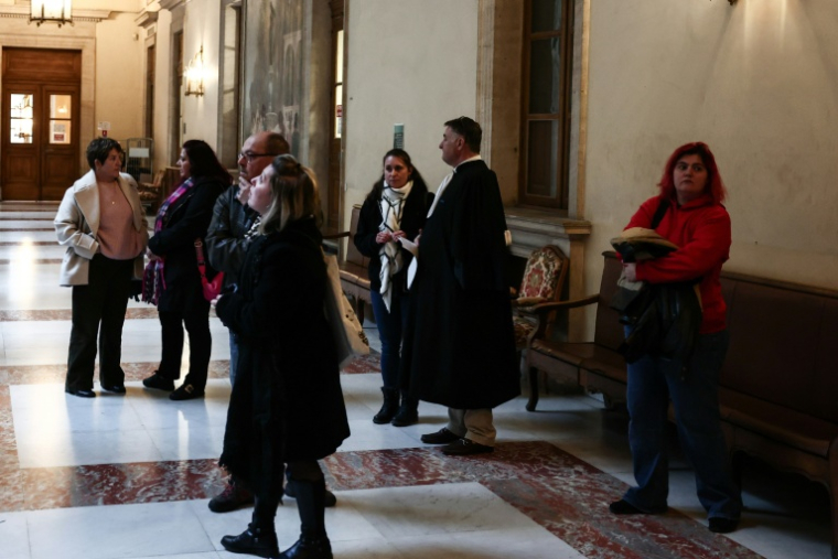 Des plaignants et leurs avocats dans la salle des pas perdus du tribunal d'Aix-en-Provence avant l'ouverture du procès de Cyril Zattara, le 5 janvier 2026 ( AFP / Thibaud MORITZ )