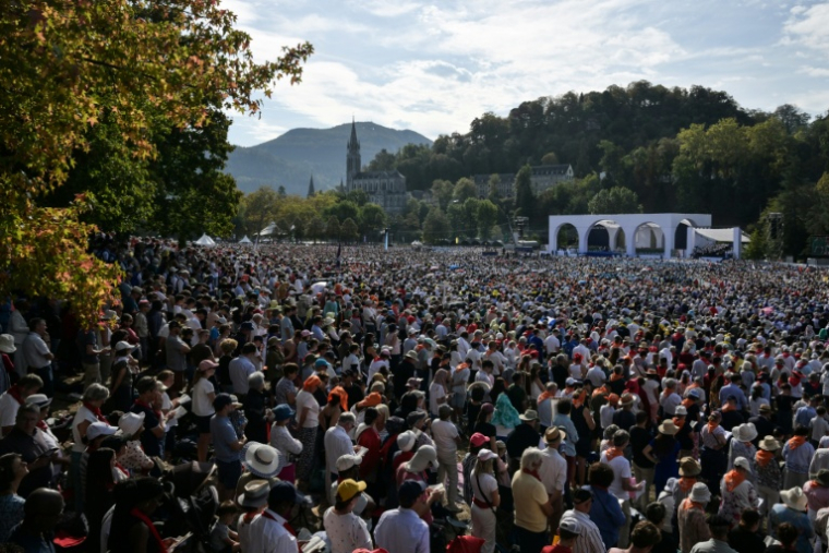 Des fidèles attendent le début de la messe célébrée par le pape Léon XIV sur la prairie du sanctuaire marial de Lourdes, le 27 septembre 2026 ( AFP / Ed JONES )