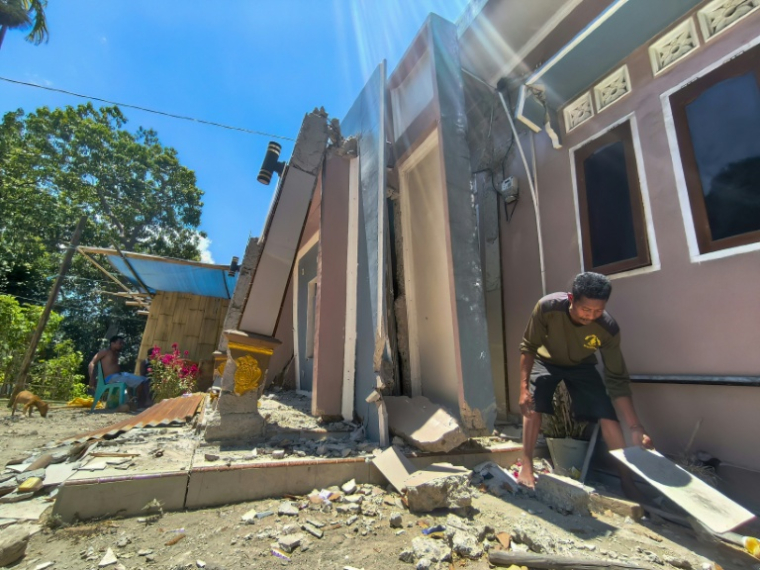Un habitant déblaie les débris de sa maison endommagée par un séisme de magnitude 7,7 survenu en août, dans le village de Meken Detun, le 14 septembre 2026 en Indonésie ( AFP / ARNOLD WELIANTO )