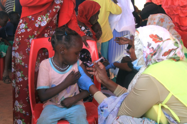 Une fillette soudanaise est vaccinée contre la diphtérie dans un camp de déplacés dans la ville d'Al-Dabbah, dans le nord du Soudan, le 22 novembre 2025 ( AFP / Ebrahim Hamid )