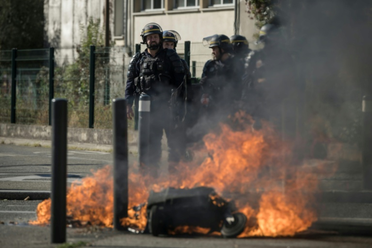 Des CRS près de poubelles en feu, lors d’une manifestation de lycéens devant le lycée Déodat à Toulouse, le 15 octobre 2026 en Haute-Garonneevances. ( AFP / Ed JONES )
