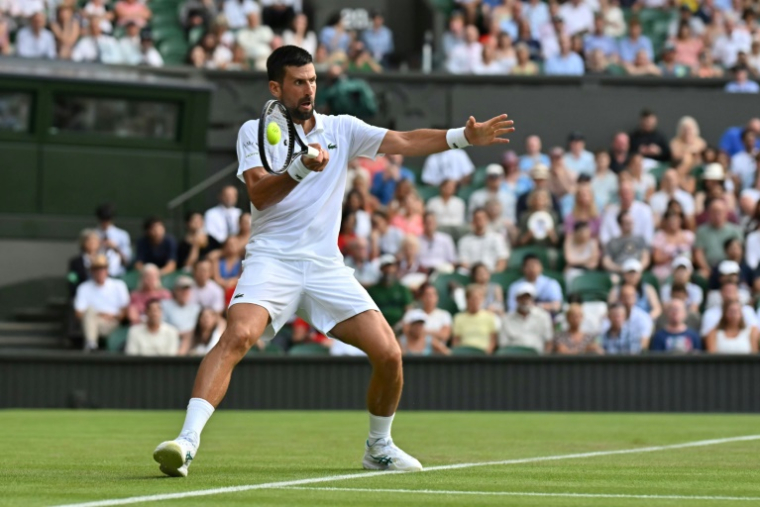 Le Serbe Novak Djokovic tape un coup droit lors de son match contre le Français Alexandre Müller, au premier tour de Wimbledon, le 1er juillet 2025 à Londres  ( AFP / Glyn KIRK )