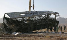 Une grue soulève l'épave d'un bus après un accident meurtrier dans le district de Guzara, dans la province d'Hérat, le 20 août 2025 en Afghanistan ( AFP / Mohsen KARIMI )