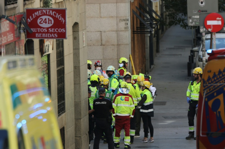 Des policiers et secouristes près du site d'un bâtiment effondré à Madrid, le 7 octobre 2025 en EspagneSpanish emergency services scrambled to a building collapse in Madrid's touristic city centre on Tuesday with local media reporting several people missing. Emergency services said on X that firefighters were working at the scene of a building undergoing refurbishment near the Spanish capital's opera. ( AFP / Thomas COEX )