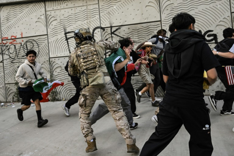 Des agents des douanes et de la protection des frontières dispersent des manifestants devant le bâtiment fédéral de Los Angeles, le 12 juin 2025 en Californie ( AFP / RONALDO SCHEMIDT )