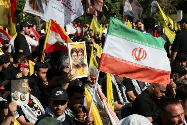 Des soutiens du Hezbollah brandissent des drapeaux de l'Iran et du mouvement chiite libanais, ainsi et la photo de son chef charismatique, Hassan Nasrallah, à l'occasion de la commémoration de son assassinat par Israël en 2024, dans la banlieue sud de Beyrouth le 27 septembre 2026 ( AFP / Anwar AMRO )