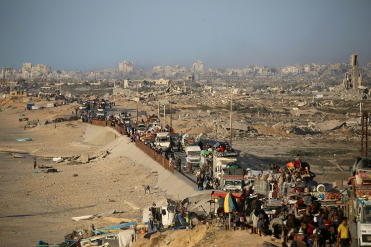 Des Palestiniens de la ville de Gaza se déplacent vers le sud de la bande de Gaza avec leurs affaires, sur la route côtière le long du camp de réfugiés de Nousseirat dans le centre du territoire, pour fuir une opération militaire israélienne, le 20 septembre 2025 ( AFP / Eyad BABA )